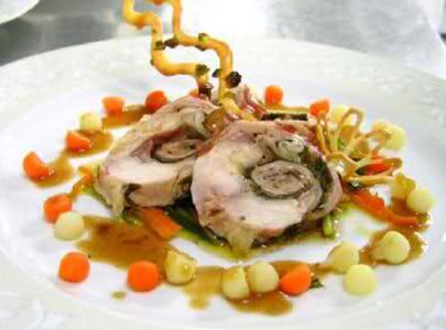 Carrè of rabbit stuffed with mousse with garden herbs, spring onions and beet greens in Bonini Traditional Balsamic Vinegar of Modena PDO Extravecchio with polenta