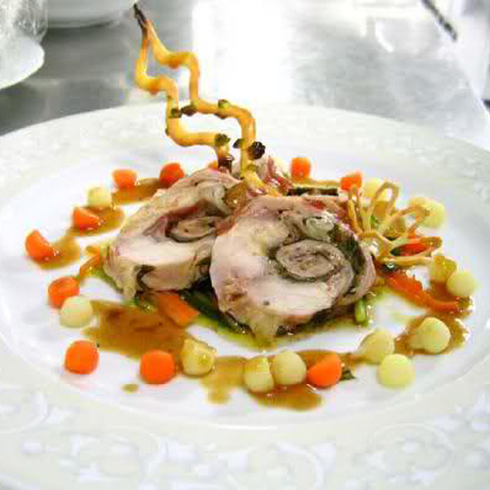 Carrè of rabbit stuffed with mousse with garden herbs, spring onions and beet greens in Bonini Traditional Balsamic Vinegar of Modena PDO Extravecchio with polenta